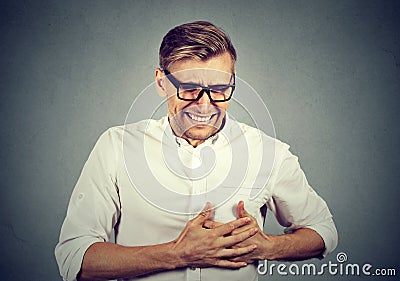 Adult man suffering from severe sharp heartache, chest pain Stock Photo