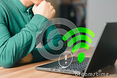 Adult man using a computer laptop to connect to wifi in his home but wifi not working, and waiting to load digital game data. Stock Photo