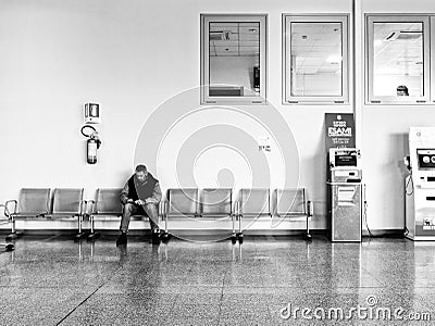 Adult man waits sitting in the hospital. Editorial Stock Photo