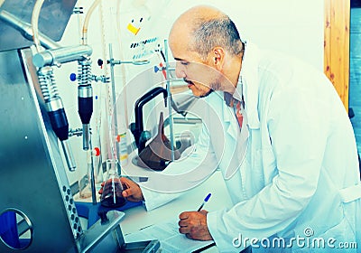 Adult man in white coat making tests Stock Photo
