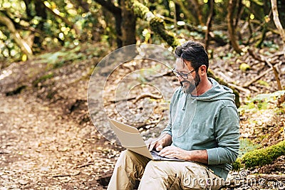 Adult man work outdoor with laptop computer - concept of digital nomad smart work job and free from office modern people - Stock Photo