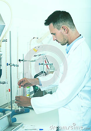 Adult man working on quality of products in lab Stock Photo