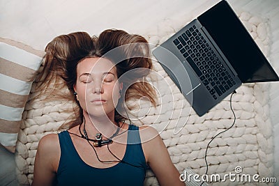 Adult mature woman doing yoga nidra and lay at home living room with online tutorials on laptop Stock Photo