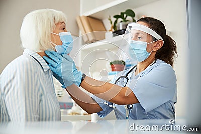 Medical practitioner searching for neck problems in a patient Stock Photo