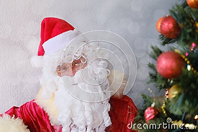 Adult santa claus with a white beard wishes a happy new year, emotionally talks about sales and discounts, the concept of Stock Photo