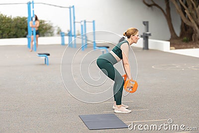 Adult sportive woman exercising with a dumbbell Stock Photo