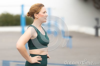 Adult sportive woman standing on the outdoors sports ground Stock Photo