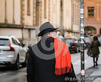 Adult in stylish clothing on busy city road Editorial Stock Photo