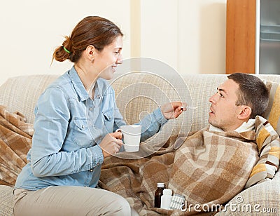 Adult woman caring for sick man Stock Photo