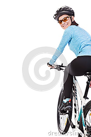 Adult woman cyclist riding a bicycle looks back and smiling. Stock Photo