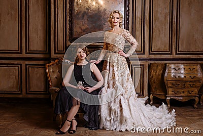 Adult woman with daughter in classic interior Stock Photo