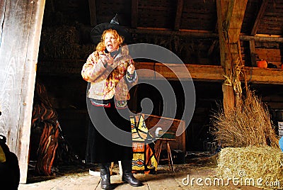 An adult woman dons a witchâ€™s cap to tell ghost stories Editorial Stock Photo