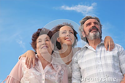 Adult woman and her parents embracing Stock Photo