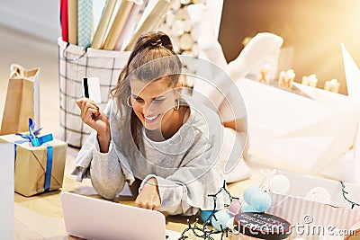 Adult woman at home wrapping Christmas presents Stock Photo