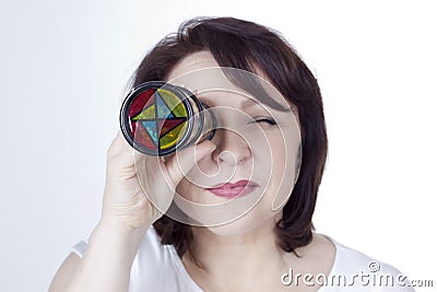 Adult woman looking into a kaleidoscope Stock Photo