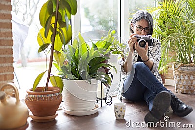 Adult woman passionate about photography with film camera Stock Photo