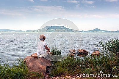 Adult woman stays on Lake Balaton in summer Stock Photo