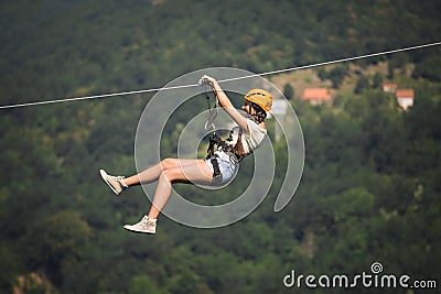 Adult woman on zip line Stock Photo