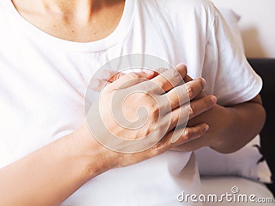 Adult women suffering from myocardial infarction, heart disease and chest pain Stock Photo