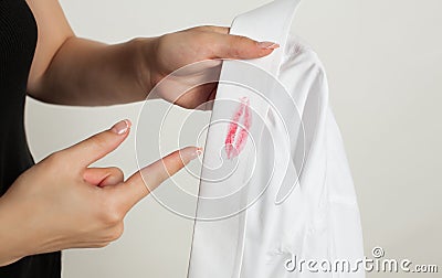 Adultery: a woman with a shirt with traces of lipstick Stock Photo