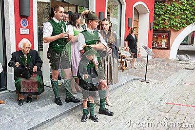 Adults and children wearing traditional Austrian custume for Pentecost Editorial Stock Photo