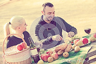 Adults drinking wine at table Stock Photo