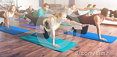 Adults having yoga class in sport club Stock Photo