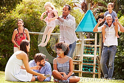 Adults and kids having fun in a garden Stock Photo
