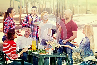 Adults relaxing at grill party Stock Photo