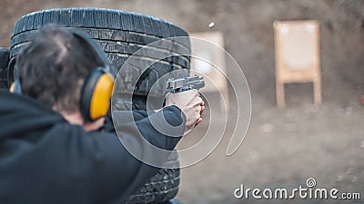 Advanced outdoor tactical shooting on target around barrier and wall Stock Photo