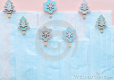 Advent calendar medical protective face mask and figures of Christmas trees, snowflakes wooden on a pink background. Decor Christm Stock Photo