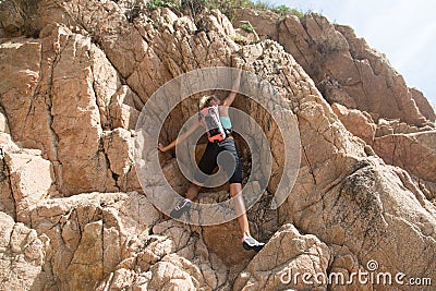 Adventure girl climbs on a cliff, rich the target Stock Photo