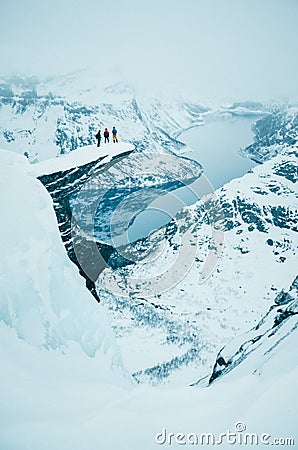 Adventure man standing on the top of the winter rock - white edit space Stock Photo