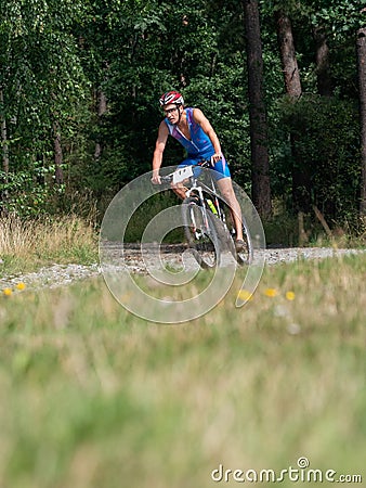 Adventure mountain bike triathlon in hilly forest terrain Editorial Stock Photo