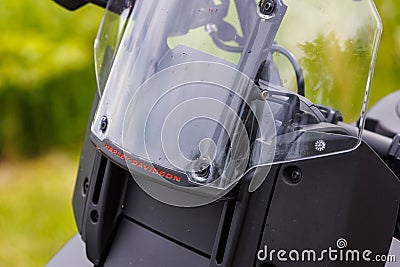 adventure plastic transparent windshield of Harley-Davidson Pan America 1250 Motorcycle, closeup with red inscription of Editorial Stock Photo