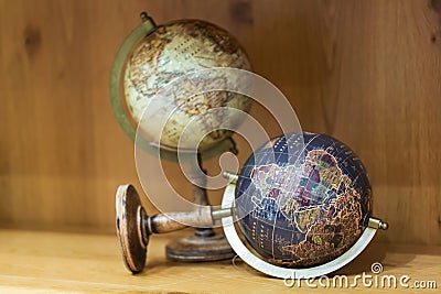 Adventure stories background. Old globe on map background. Stock Photo