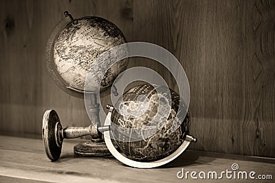 Adventure stories background. Old globe on map background. Stock Photo