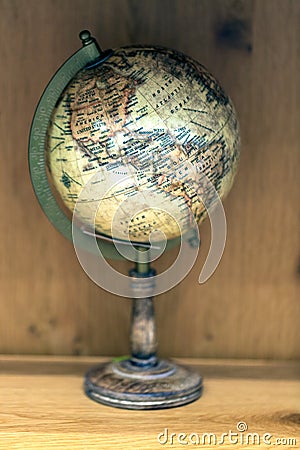 Adventure stories background. Old globe on map background. Stock Photo