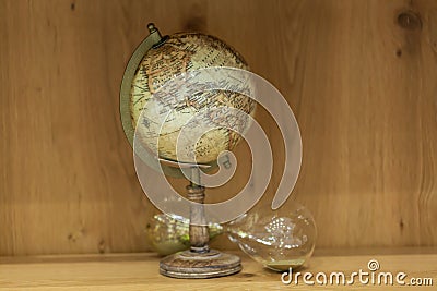 Adventure stories background. Old globe on map background. Stock Photo