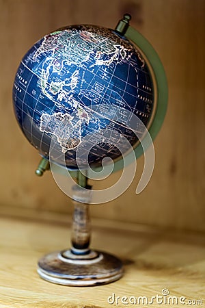 Adventure stories background. Old globe on map background. Stock Photo