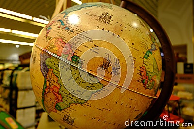 Adventure stories background. Old globe on map background. Selective focus. Editorial Stock Photo