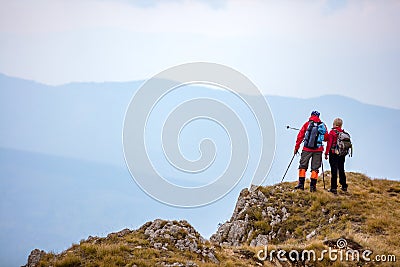 Adventure, travel, tourism, hike and people concept - smiling couple walking with backpacks outdoors Stock Photo