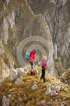 Adventure, travel, tourism, hike and people concept - smiling couple walking with backpacks outdoors Stock Photo