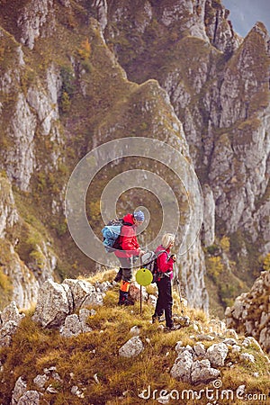 Adventure, travel, tourism, hike and people concept - smiling couple walking with backpacks outdoors Stock Photo