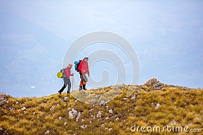 Adventure, travel, tourism, hike and people concept - smiling couple walking with backpacks outdoors Stock Photo