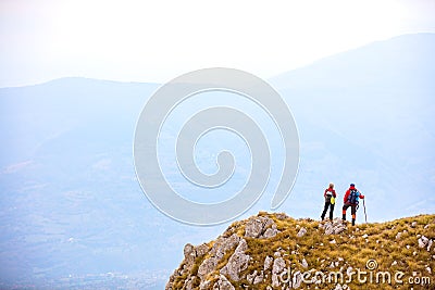 Adventure, travel, tourism, hike and people concept - smiling couple walking with backpacks outdoors Stock Photo