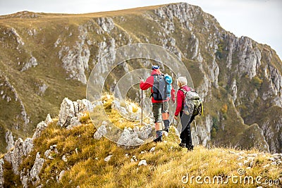 Adventure, travel, tourism, hike and people concept - smiling couple walking with backpacks outdoors Stock Photo