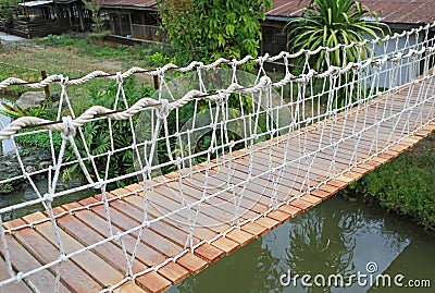 Adventure wooden rope suspension bridge Stock Photo