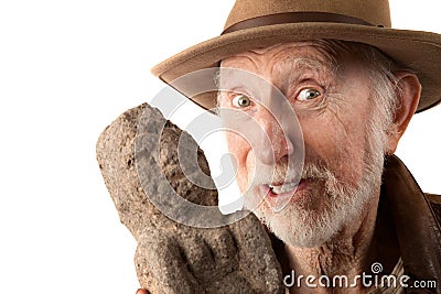 Adventurer or archaeologist with idol Stock Photo