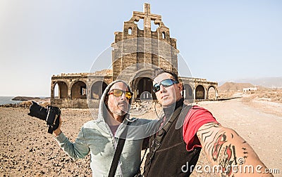 Adventurous best friends taking selfie at abandoned place in Tenerife Stock Photo